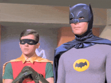 robin and batman are standing next to each other