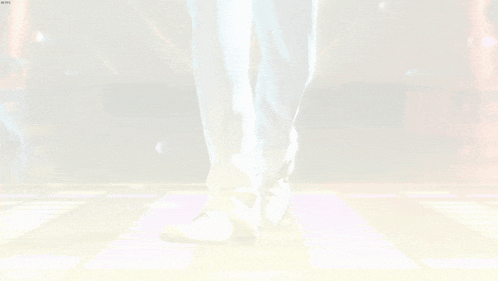 a person is standing on a dance floor with a blurred background .