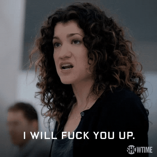a woman with curly hair says " i will fuck you up showtime "