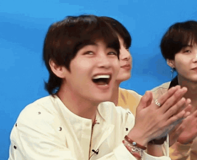 a man with a ring on his finger is clapping