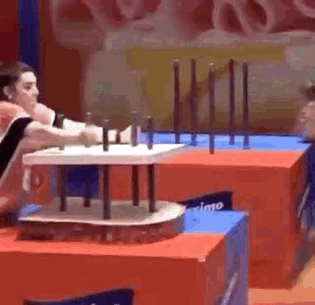 a man is sitting on a table with a bunch of sticks on it .