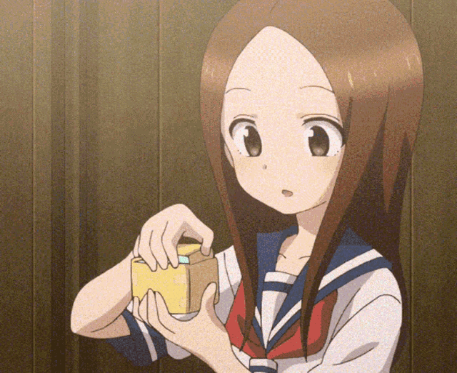 a girl in a school uniform is holding a cube in her hands