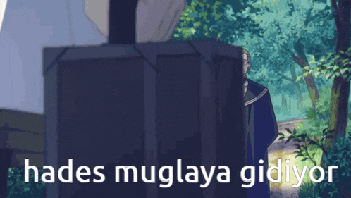 a man is standing in front of a box that says hades muglaya gidiyor on it