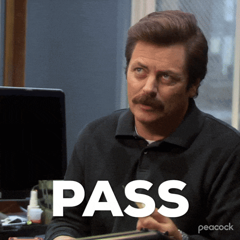 a man with a mustache is sitting at a desk with the word pass written on the screen