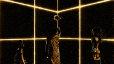 a man in a leather jacket stands in front of a screen with a lot of lights