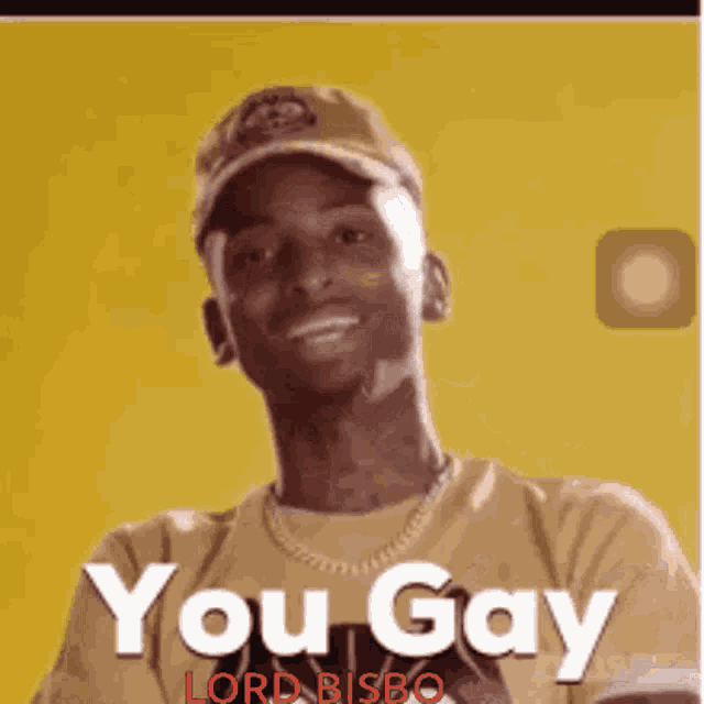 a man wearing a hat and a yellow shirt with the words you gay written on it .