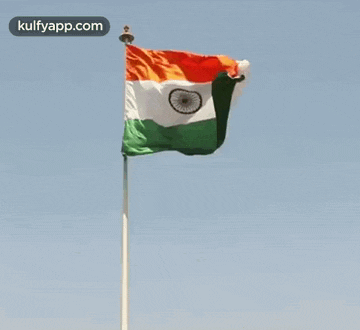 a flag is waving in the wind on a pole .
