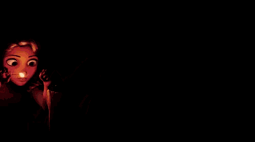 rapunzel from tangled is standing in front of three lit candles in a dark room .