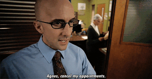 a bald man wearing glasses and a blue shirt says agnes cancel my appointments