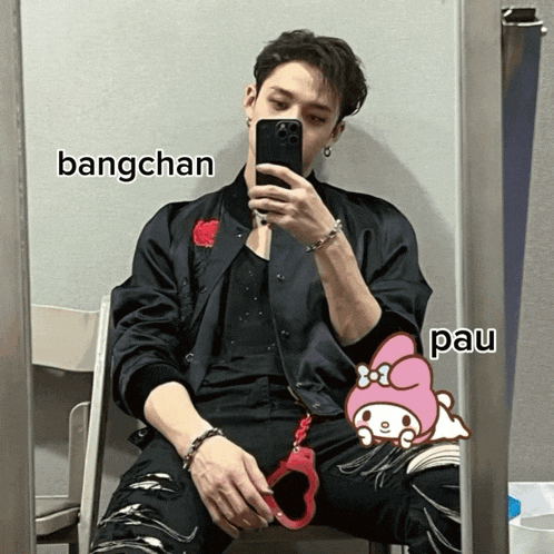 a man is taking a picture of himself in front of a mirror with bangchan and pau written on the bottom