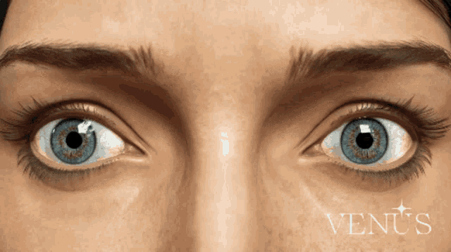 a close up of a woman 's eyes with the word venus written below them