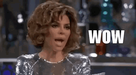 a woman in a sequined dress is making a surprised face while talking .
