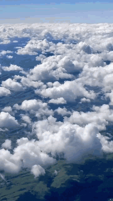 an aerial view of a cloudy sky above a valley