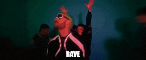 a man with green hair is wearing sunglasses and the word rave is on the screen