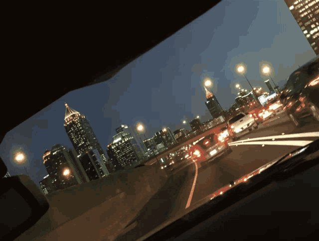 a car is driving down a highway at night