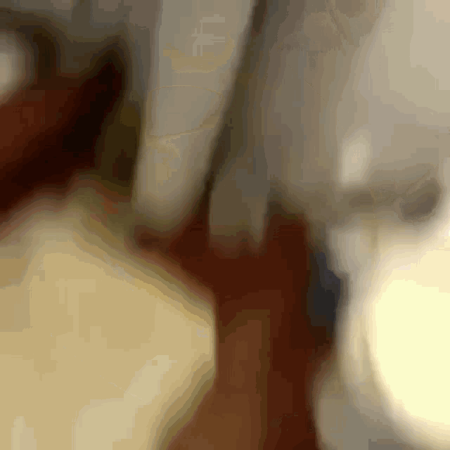 a blurry picture of a person 's hand reaching out towards a toilet