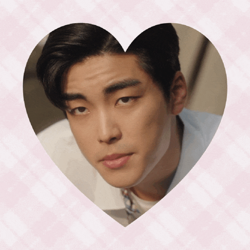 a close up of a man 's face inside of a heart shaped frame
