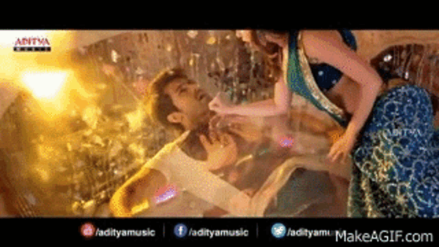 a man and a woman are dancing in a room in a video .