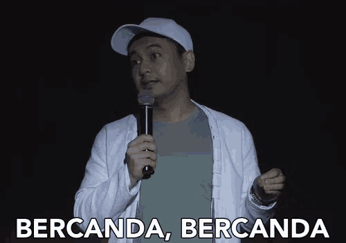 a man holding a microphone with the words bercanda bercanda above him