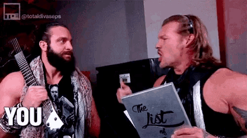 two men are standing next to each other holding a book that says the list