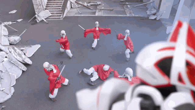 a group of people in red and white uniforms are standing in a circle holding swords