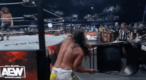 a man in a wrestling ring with the word aew on the front