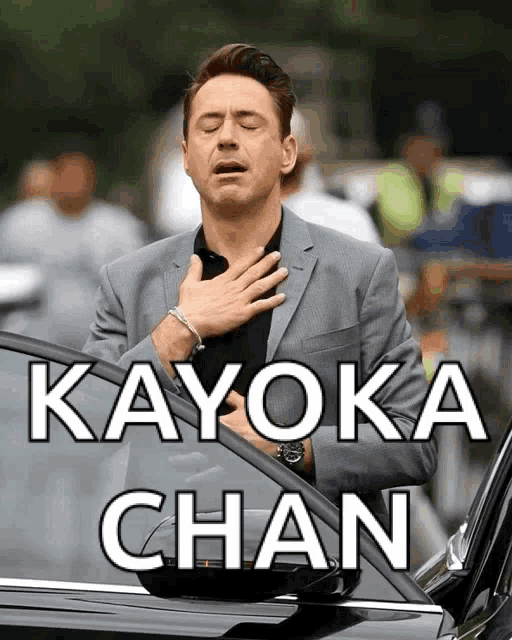 a man in a suit with his hands on his chest and the words kayoka chan