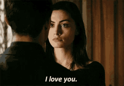 a woman is kissing a man on the forehead and saying `` i love you '' .