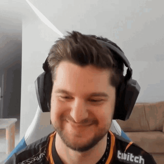 a man wearing headphones and a shirt with the word twitch on it