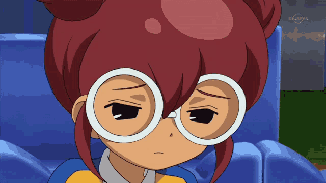 a cartoon character with red hair and white glasses is sitting on a blue couch