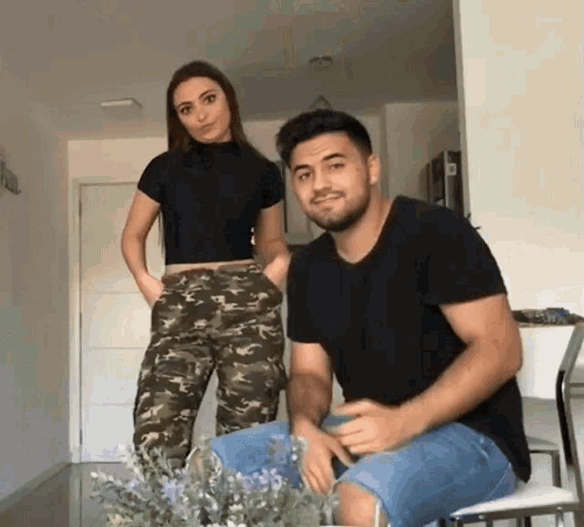 a man and a woman are posing for a picture
