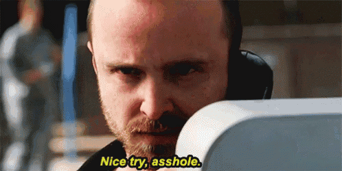 a man with a beard is talking on a cell phone and says `` nice try , asshole . ''