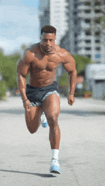 a shirtless man is running down the street