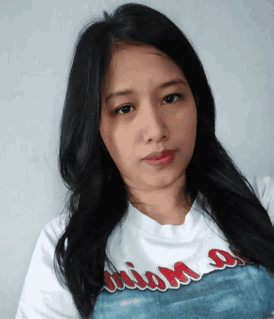 a woman wearing a white shirt that says miami