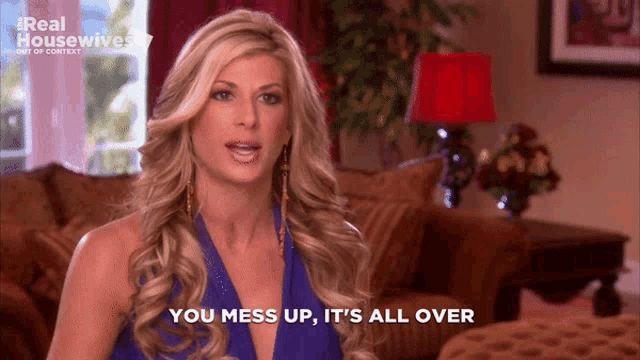 a woman says " you mess up it 's all over " in a living room