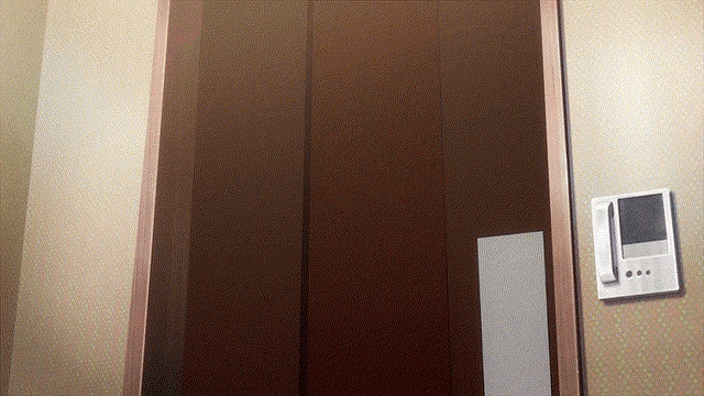 a brown door with a white telephone on the wall next to it