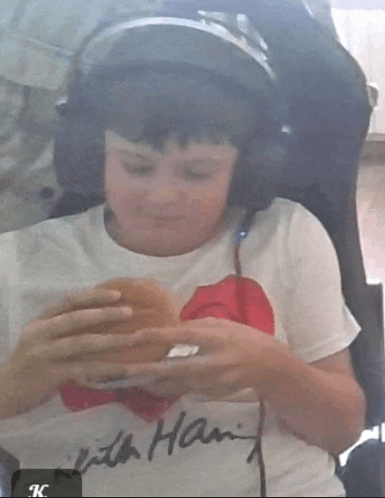 a boy wearing headphones and a little ham shirt