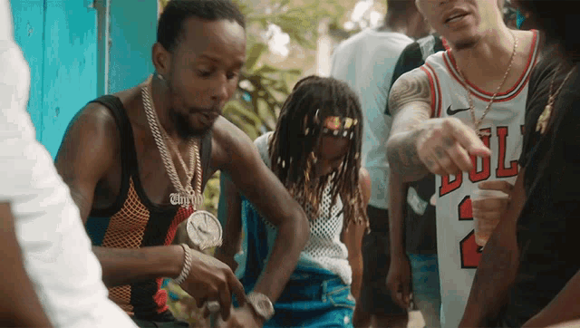 a man in a chicago bulls jersey is pointing