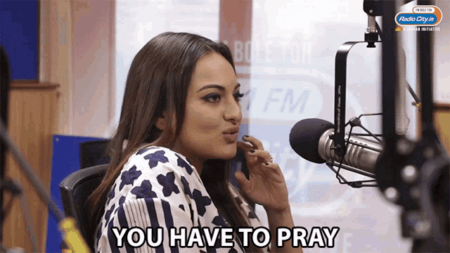 a woman sitting in front of a microphone with the words " you have to pray " below her