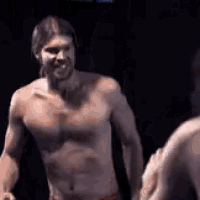 a shirtless man is standing in front of a mirror and smiling