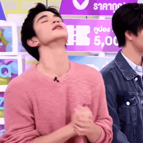 a man in a pink sweater is standing next to another man