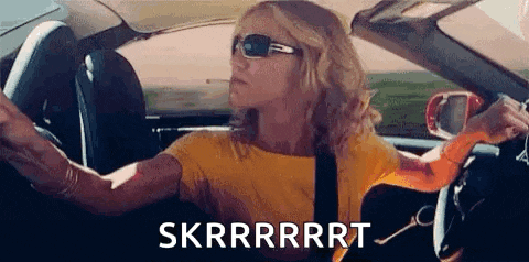 a woman is driving a car with a guitar in her hand and a cigarette in her mouth .