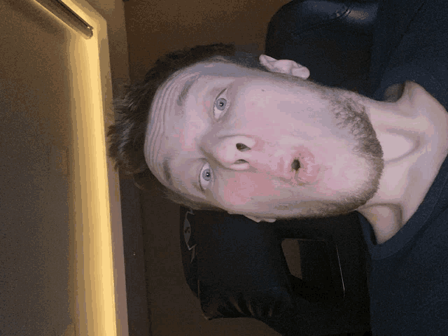 a man with a beard is making a funny face with his mouth open