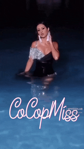 a woman in a black dress is standing in a pool with the words cocop miss on the bottom