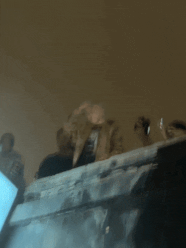 a blurry picture of a person standing in a dark room with smoke coming out of them