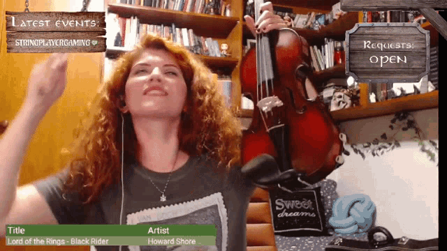 a woman is playing a violin in front of a sign that says " requests open "