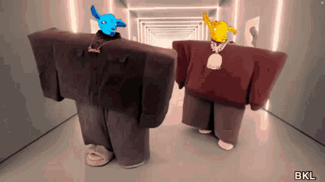 two cartoon characters are standing next to each other in a hallway with the letters bkl on the bottom