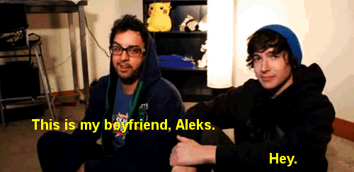 a man sitting next to another man with the words this is my boyfriend aleks