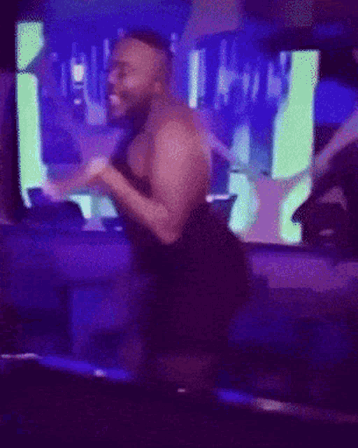 a blurry picture of a man standing in a dark room with blue lights