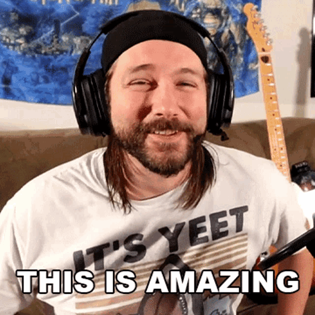 a man wearing headphones and a t-shirt that says it 's yeet this is amazing